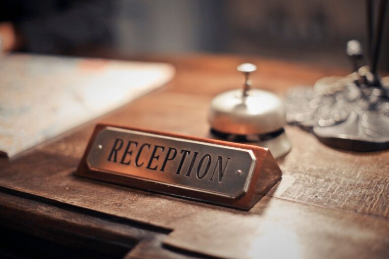 selective focus photo of reception signage