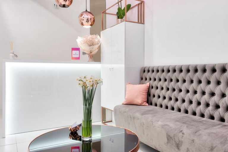 modern sofa and reflecting table near reception counter in salon